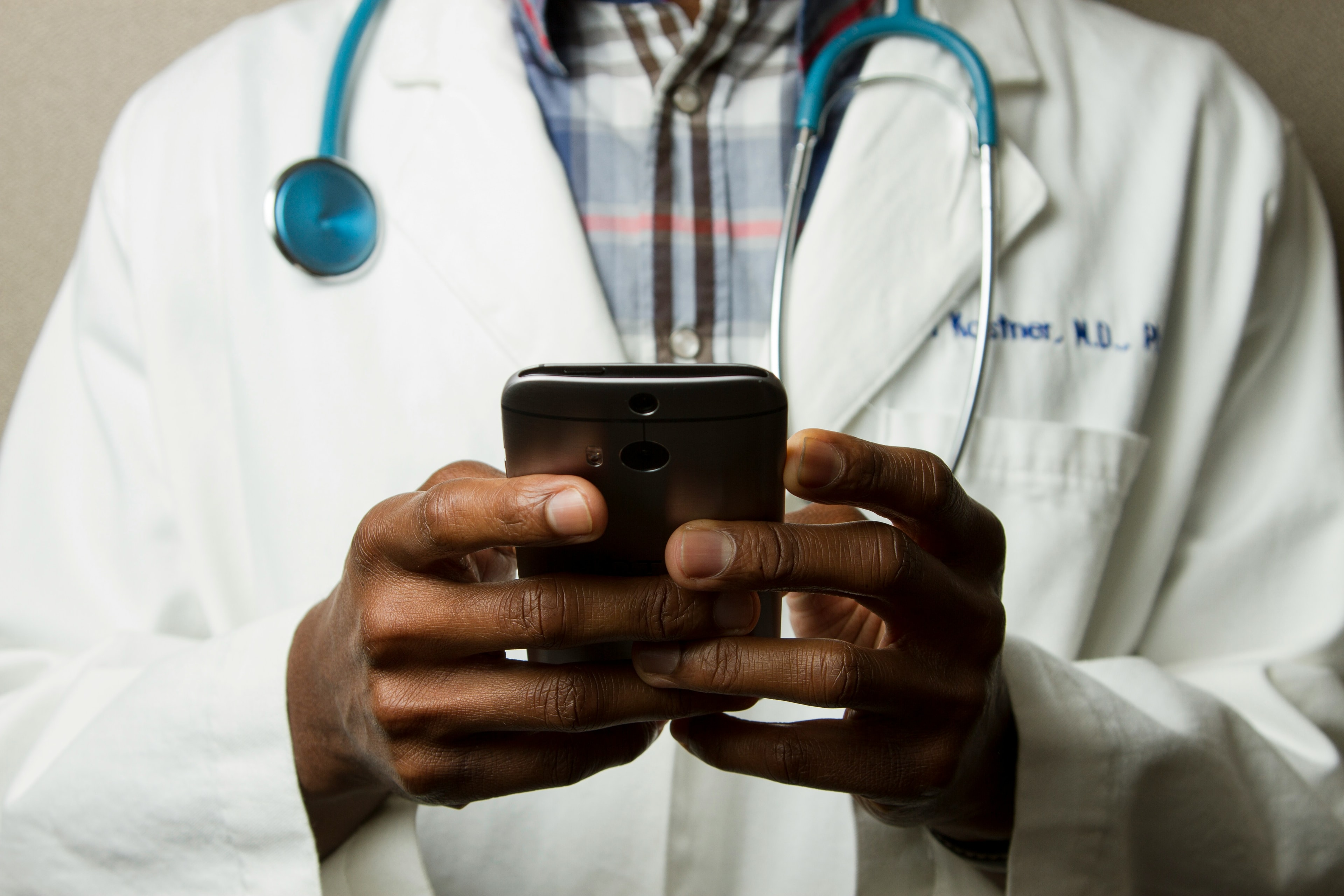 Medical professional with stethoscope and smartphone